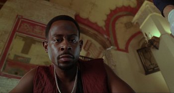 Movie still from “Bad Boys” (1995), directed by Michael Bay – A person wearing a red vest; Close Up shot, Low angle