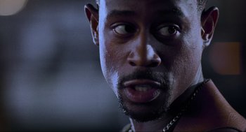 Movie still from “Bad Boys” (1995), directed by Michael Bay – A man's eyes and face; Close Up shot, Over the shoulder angle