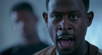 Movie still from “Bad Boys” (1995), directed by Michael Bay – A man's face as he stares at the camera; Close Up shot, Low angle