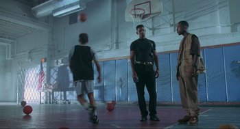 Movie still from “Bad Boys” (1995), directed by Michael Bay – A group of young men playing a game of basketball; Wide shot, Low angle
