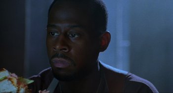 Movie still from “Bad Boys” (1995), directed by Michael Bay – A person wearing a brown shirt; Close Up shot, Low angle