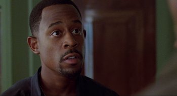 Movie still from “Bad Boys” (1995), directed by Michael Bay – A person looking at the camera; Close Up shot, Over the shoulder angle