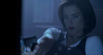 Movie still from “Bad Boys” (1995), directed by Michael Bay – A woman holding a gun in a room with lights; Close Up shot, Low angle