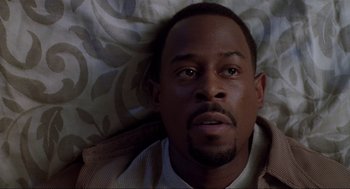 Movie still from “Bad Boys” (1995), directed by Michael Bay – A person laying in a bed; Close Up shot, High angle