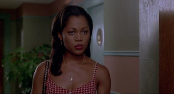 Movie still from “Bad Boys” (1995), directed by Michael Bay – A woman with a cross necklace; Close Up shot, Over the shoulder angle