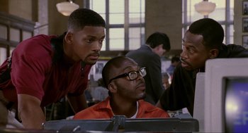 Movie still from “Bad Boys” (1995), directed by Michael Bay – A group of men standing next to a computer screen; Medium shot, Low angle