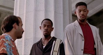 Movie still from “Bad Boys” (1995), directed by Michael Bay – A group of men standing next to each other; Medium shot, Low angle