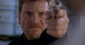 Movie still from “Bad Boys” (1995), directed by Michael Bay – A person holding a gun; Close Up shot, Low angle