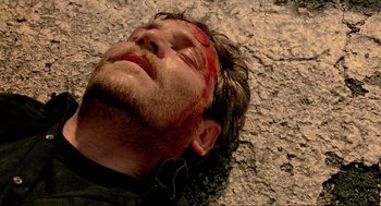 Movie still from “Bad Boys” (1995), directed by Michael Bay – A person laying on the ground with blood on his face; Close Up shot, Overhead angle