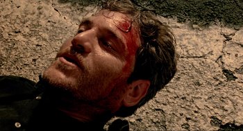 Movie still from “Bad Boys” (1995), directed by Michael Bay – A person laying on the ground with blood on his face; Close Up shot, Overhead angle