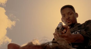Movie still from “Bad Boys” (1995), directed by Michael Bay – A man is holding a gun in his hand; Close Up shot, Low angle