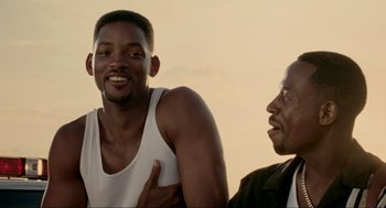 Movie still from “Bad Boys” (1995), directed by Michael Bay – A man and a man sitting next to each other; Close Up shot, Low angle