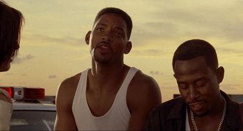 Movie still from “Bad Boys” (1995), directed by Michael Bay – A man in a white tank top and a man in a black shirt; Close Up shot, Low angle