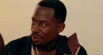 Movie still from “Bad Boys” (1995), directed by Michael Bay – A person wearing a leather jacket; Close Up shot, Over the shoulder angle