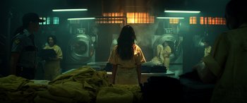 Movie still from “Bad Boys for Life” (2020), directed by Adil El Arbi – A woman standing in front of a washing machine in a room; Wide shot, Low angle