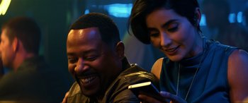 Movie still from “Bad Boys for Life” (2020), directed by Adil El Arbi – A man and a woman looking at a cell phone; Close Up shot, Over the shoulder angle
