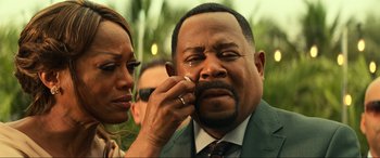 Movie still from “Bad Boys for Life” (2020), directed by Adil El Arbi – A man in a green suit crying while a woman adjusts his ring; Close Up shot, Over the shoulder angle