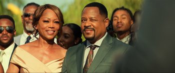 Movie still from “Bad Boys for Life” (2020), directed by Adil El Arbi – A man in a suit and tie standing next to a woman; Close Up shot, Over the shoulder angle