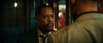 Movie still from “Bad Boys for Life” (2020), directed by Adil El Arbi – A man in a suit and a tie; Close Up shot, Over the shoulder angle