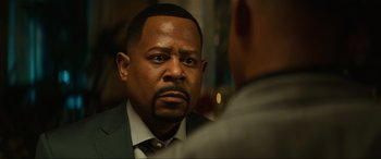 Movie still from “Bad Boys for Life” (2020), directed by Adil El Arbi – A person wearing a suit and a tie; Close Up shot, Over the shoulder angle