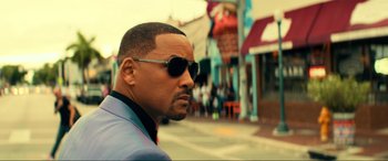 Movie still from “Bad Boys for Life” (2020), directed by Adil El Arbi – A person wearing sunglasses on the street; Close Up shot, Low angle