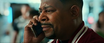 Movie still from “Bad Boys for Life” (2020), directed by Adil El Arbi – A person talking on a cell phone; Close Up shot, High angle