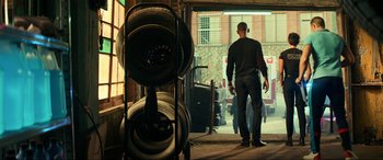 Movie still from “Bad Boys for Life” (2020), directed by Adil El Arbi – A man standing in front of a garage door; Wide shot, Low angle