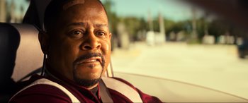 Movie still from “Bad Boys for Life” (2020), directed by Adil El Arbi – A person in a car with a bandage on his head; Close Up shot, Over the shoulder angle