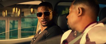 Movie still from “Bad Boys for Life” (2020), directed by Adil El Arbi – Two men in a car one wearing sunglasses and the other wearing a suit; Close Up shot, Over the shoulder angle