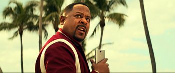 Movie still from “Bad Boys for Life” (2020), directed by Adil El Arbi – A person holding a cell phone; Close Up shot, Over the shoulder angle