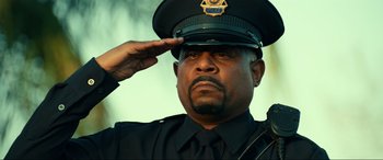 Movie still from “Bad Boys for Life” (2020), directed by Adil El Arbi – A police officer saluting while wearing a uniform; Close Up shot, Low angle