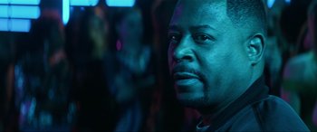 Movie still from “Bad Boys for Life” (2020), directed by Adil El Arbi – A person wearing a black shirt; Close Up shot, Over the shoulder angle