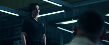 Movie still from “Bad Boys for Life” (2020), directed by Adil El Arbi – A woman in a police uniform standing in a building; Medium shot, Over the shoulder angle