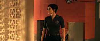 Movie still from “Bad Boys for Life” (2020), directed by Adil El Arbi – A woman standing in front of a brick wall; Medium shot, Over the shoulder angle