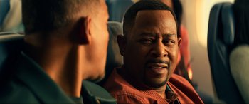 Movie still from “Bad Boys for Life” (2020), directed by Adil El Arbi – Two men are sitting together and one of them is looking at the camera; Close Up shot, Over the shoulder angle