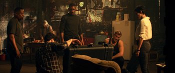 Movie still from “Bad Boys for Life” (2020), directed by Adil El Arbi – A group of people standing around a suitcase; Wide shot, High angle