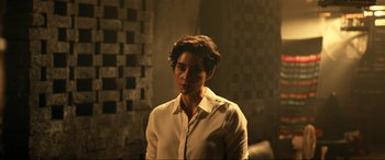 Movie still from “Bad Boys for Life” (2020), directed by Adil El Arbi – A woman in a white shirt is standing in a room; Medium shot, Over the shoulder angle
