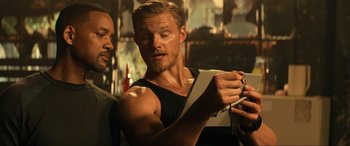 Movie still from “Bad Boys for Life” (2020), directed by Adil El Arbi – A man looking at a camera while another man looks on; Close Up shot, Over the shoulder angle