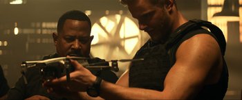 Movie still from “Bad Boys for Life” (2020), directed by Adil El Arbi – Two men are looking at their cell phones; Medium shot, Over the shoulder angle