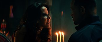 Movie still from “Bad Boys for Life” (2020), directed by Adil El Arbi – A woman standing in front of a lit candle; Close Up shot, Over the shoulder angle