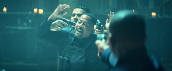 Movie still from “Bad Boys for Life” (2020), directed by Adil El Arbi – A group of men holding guns in front of a mirror; Medium shot, Over the shoulder angle