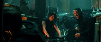 Movie still from “Bad Boys for Life” (2020), directed by Adil El Arbi – A man and a woman working in a room; Medium shot, High angle