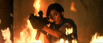 Movie still from “Bad Boys for Life” (2020), directed by Adil El Arbi – A woman holding a gun in front of a fire; Medium shot, Low angle