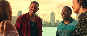 Movie still from “Bad Boys for Life” (2020), directed by Adil El Arbi – Two men standing next to each other near a body of water; Medium shot, Over the shoulder angle