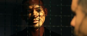 Movie still from “Bad Boys for Life” (2020), directed by Adil El Arbi – A person behind a metal fence; Close Up shot, Low angle