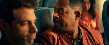 Movie still from “Bad Boys for Life” (2020), directed by Adil El Arbi – Two men are sitting on a couch and one of them is talking to another man; Close Up shot, Over the shoulder angle