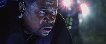 Movie still from “Bad Boys II” (2003), directed by Michael Bay – A man's face in front of a light; Close Up shot, Low angle
