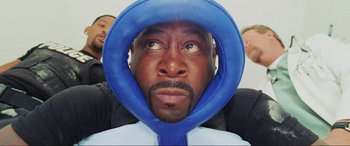 Movie still from “Bad Boys II” (2003), directed by Michael Bay – A person wearing a blue hat; Close Up shot, Overhead angle