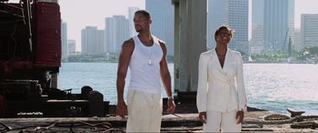 Movie still from “Bad Boys II” (2003), directed by Michael Bay – A man and a woman standing next to a body of water; Medium shot, Low angle