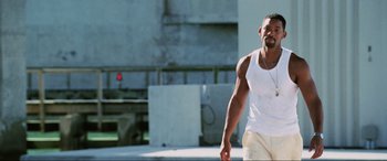 Movie still from “Bad Boys II” (2003), directed by Michael Bay – A man in a white tank top and white shorts; Medium shot, Low angle